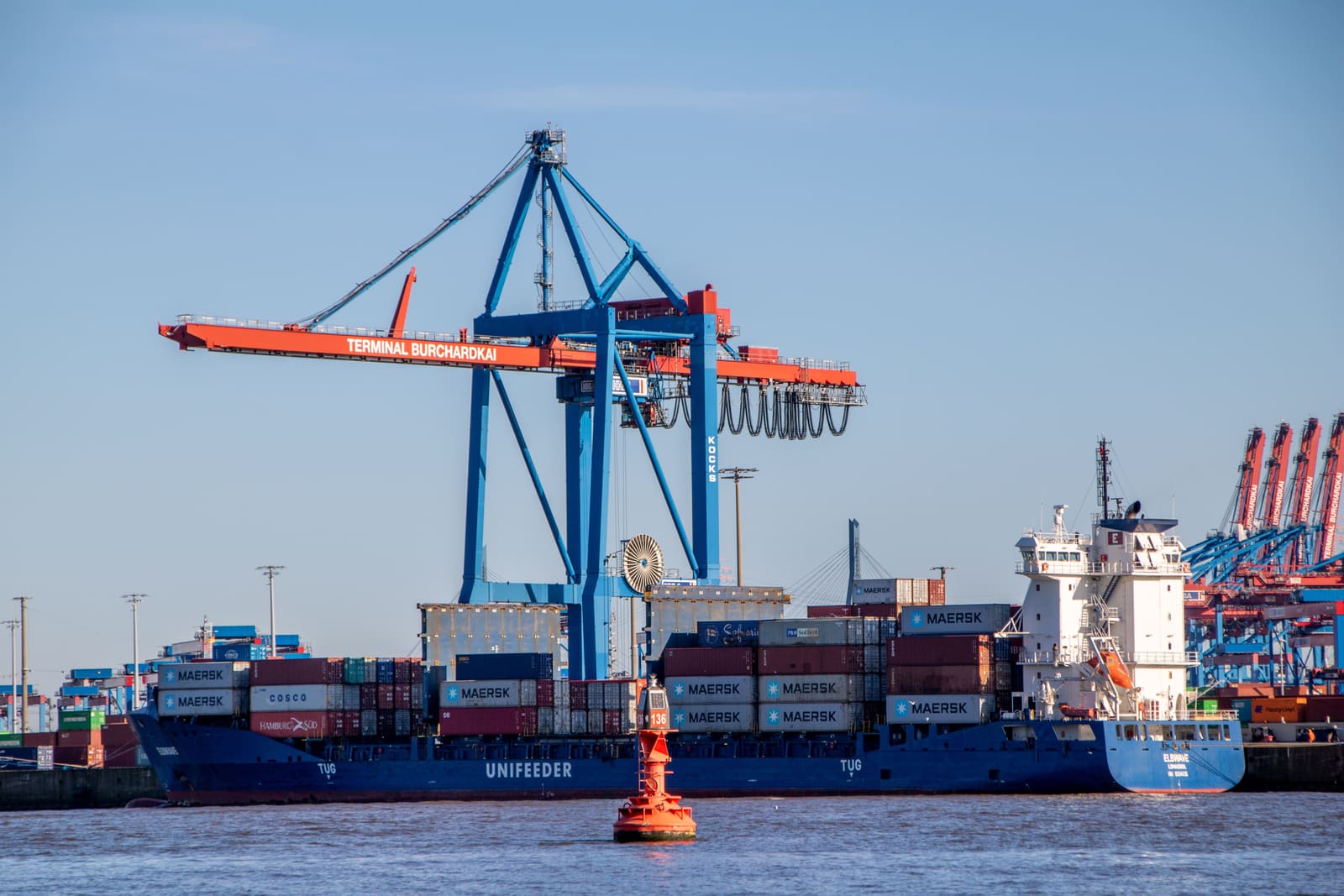 Port cranes loading shipping containers onto vessels
