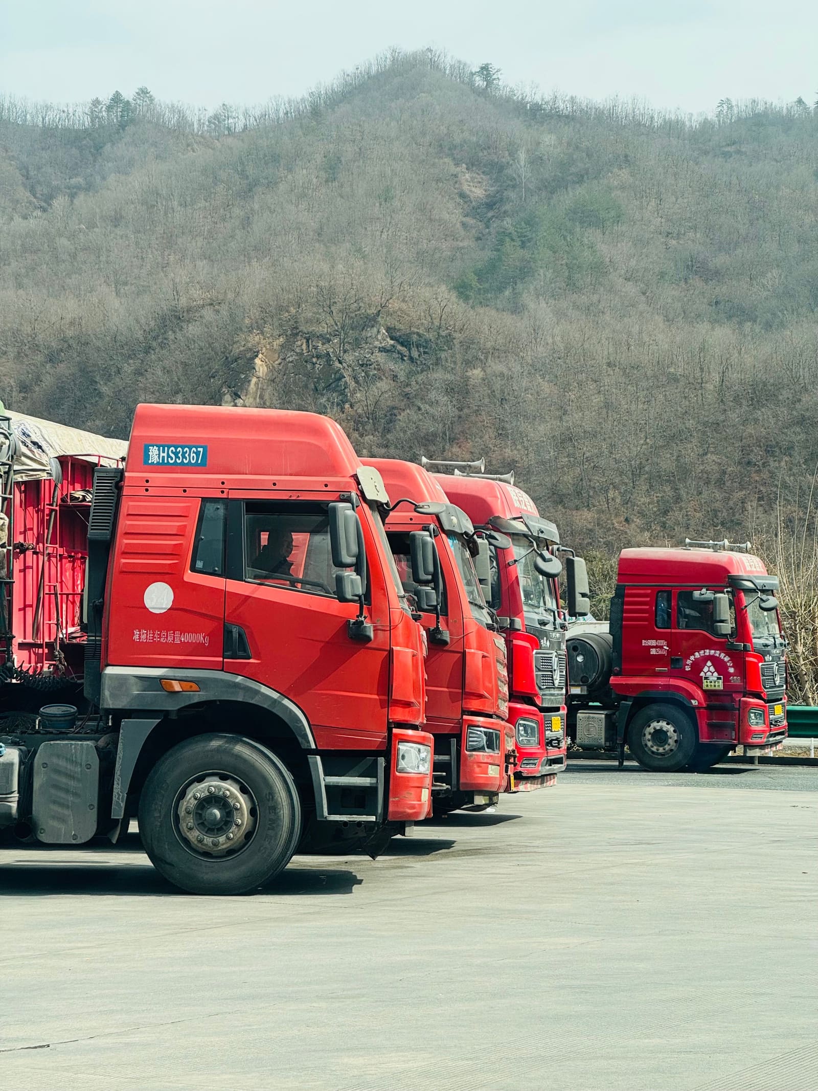Fleet of freight trucks lined up at a logistics depot