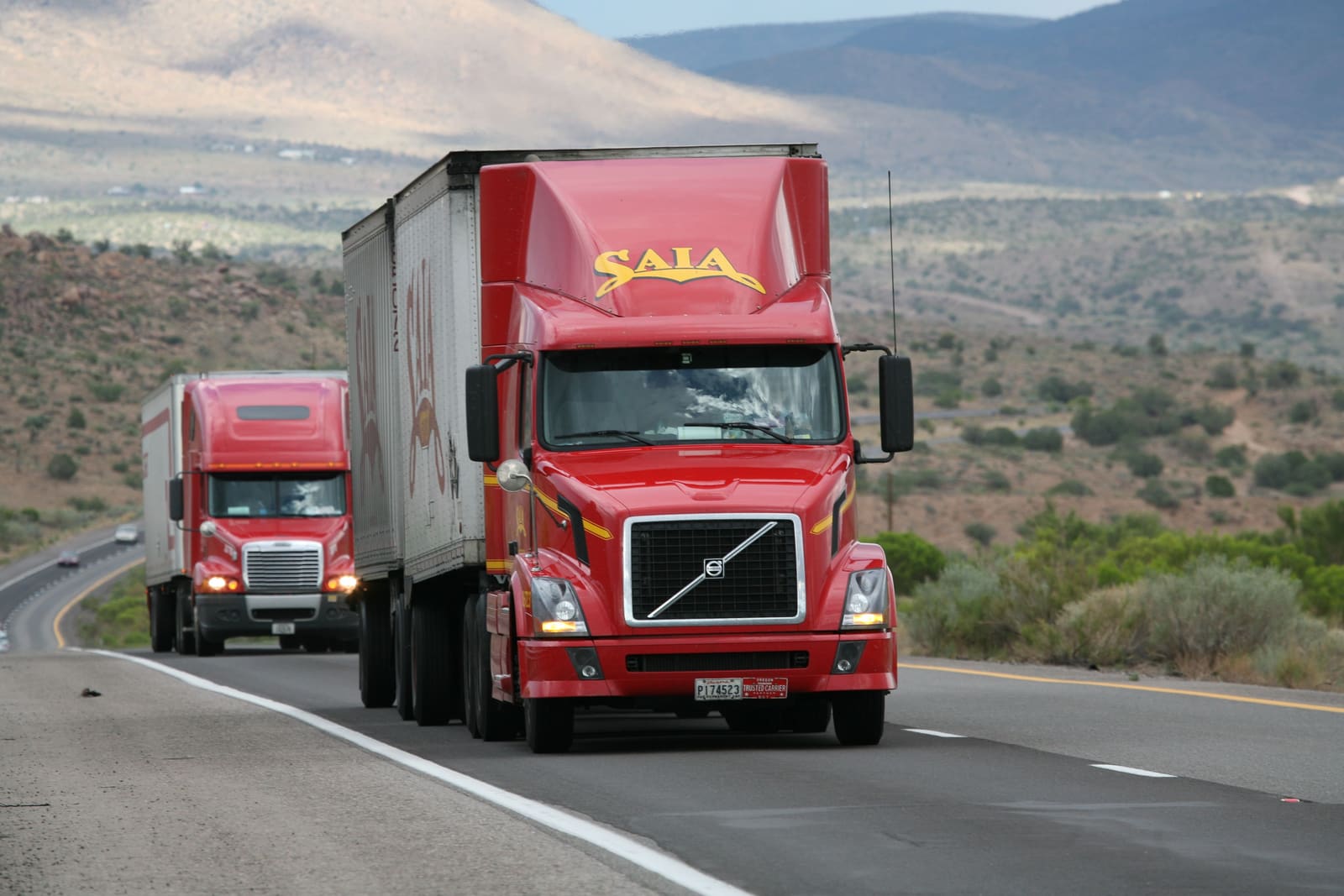 Semi-trucks hauling freight on an interstate highway
