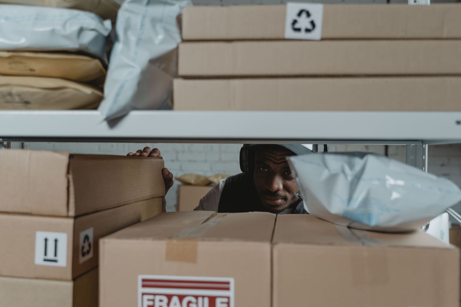 Package inspector examining a parcel for shipment insurance quality control